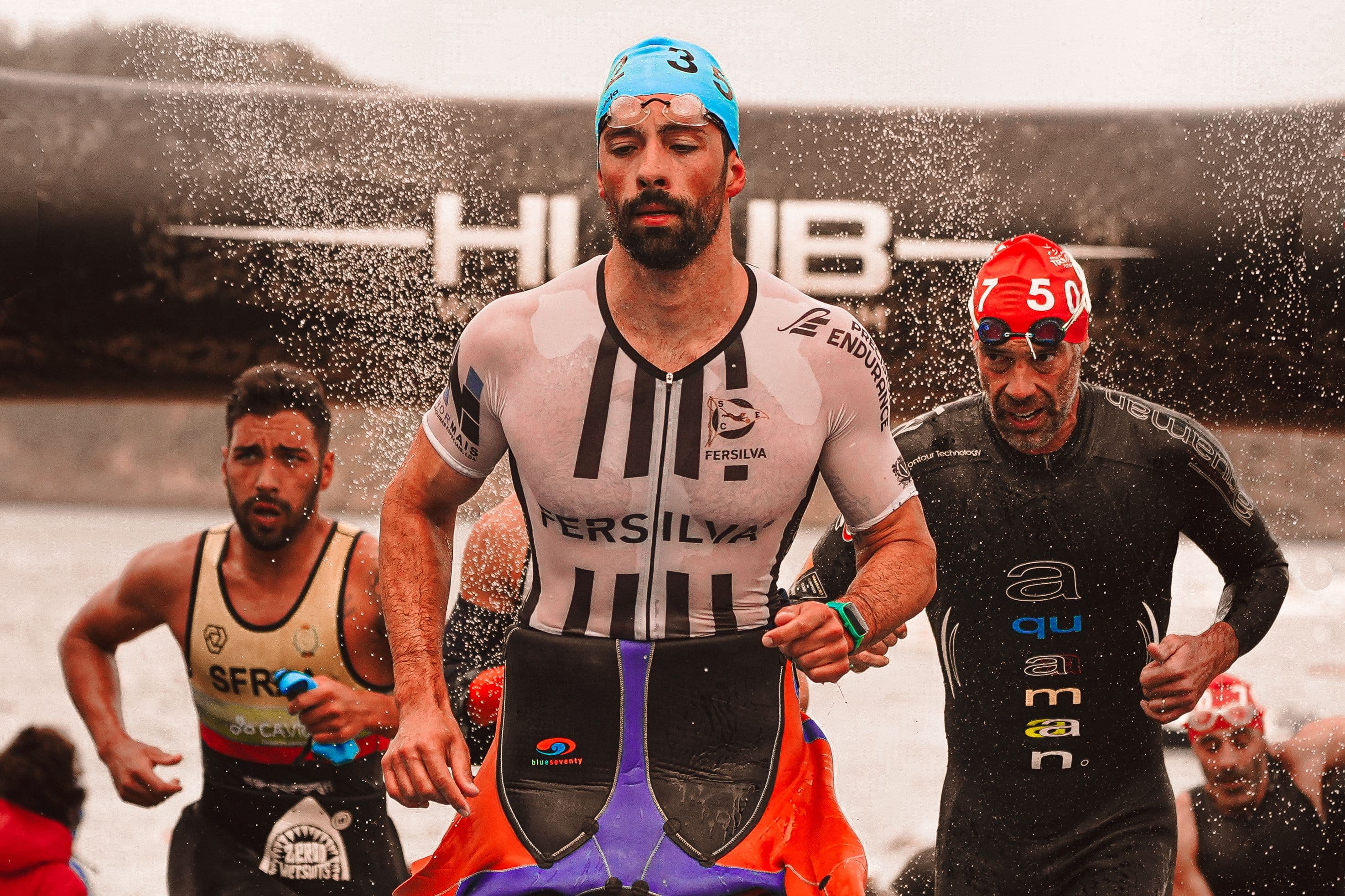 Athletes in performance kit coming out of the water