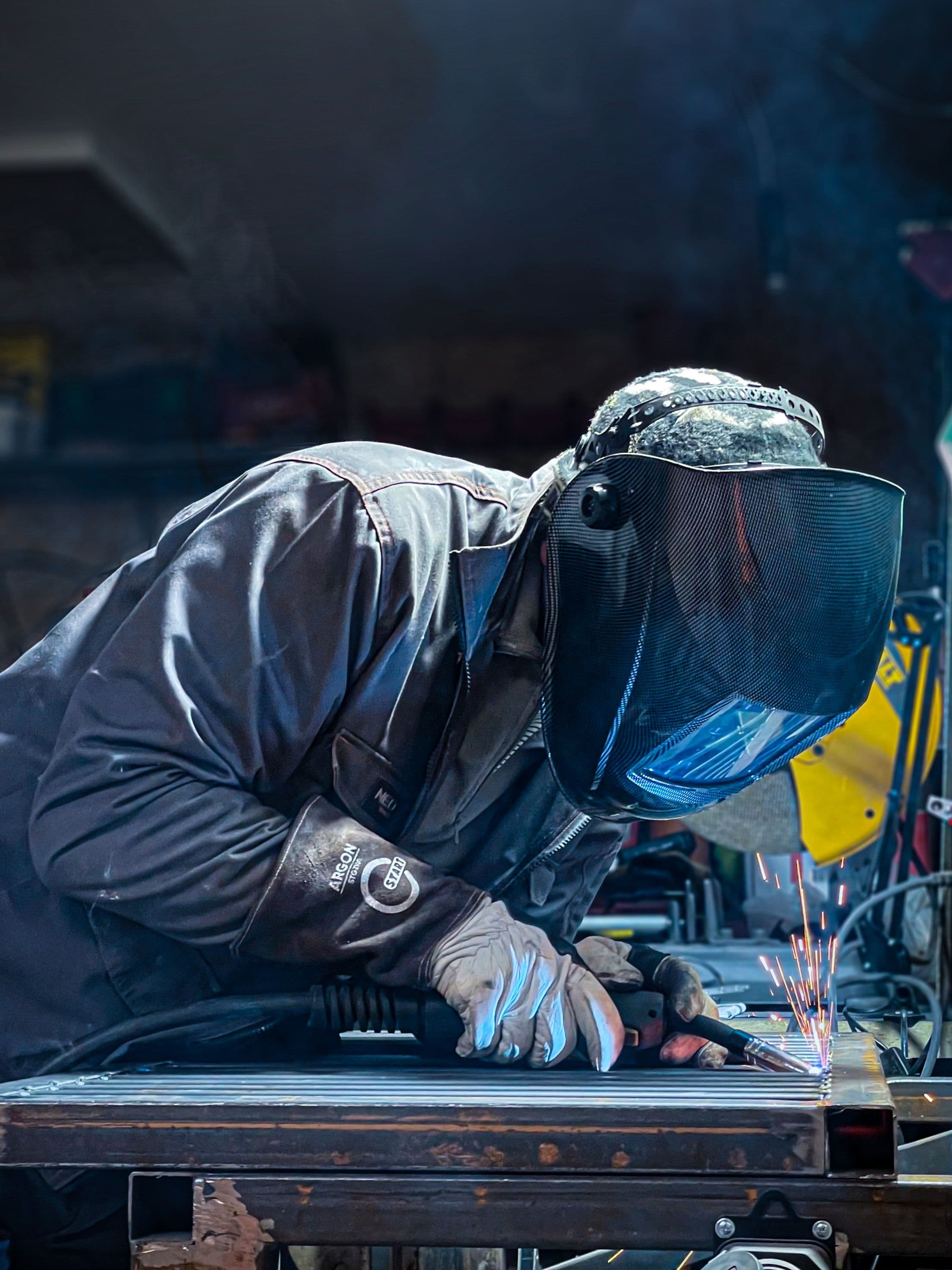 Factory worker in blue coveralls and a hard hat